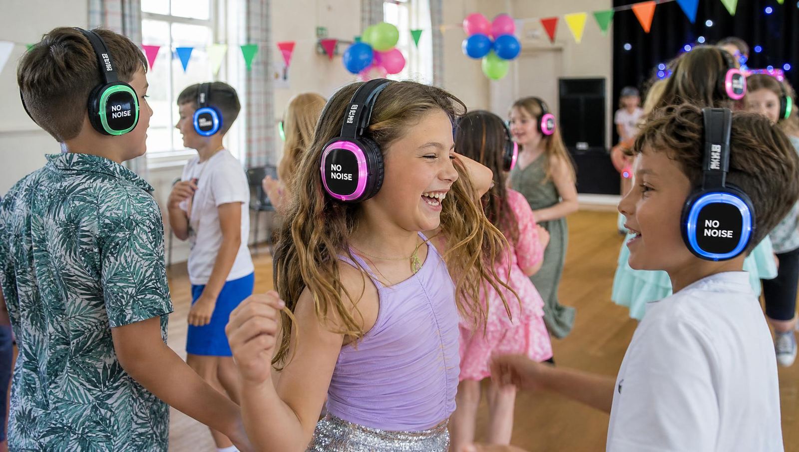 Children's birthday silent disco party in a Devon village hall with NO NOISE branded LED headphones